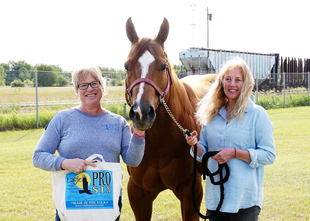 Linda and Jill with standing with a horse.