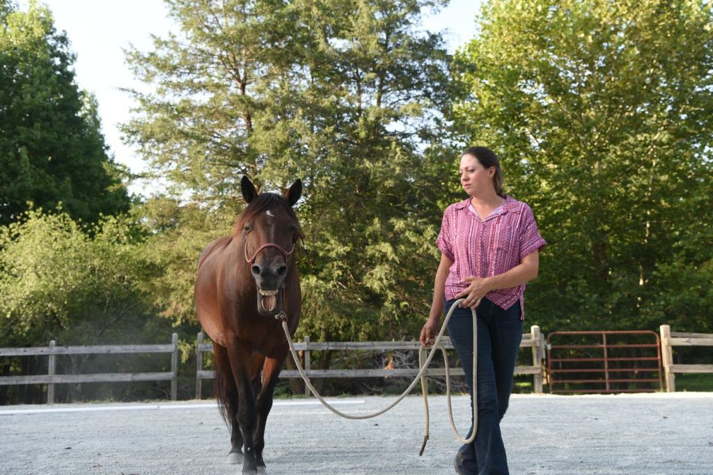 Amy Skinner walking with her horse.